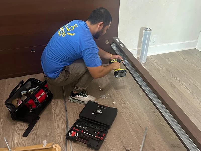 Movers disassembling furniture